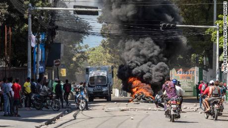 Tires are set ablaze during a march in Port-au-Prince on February 10, 2021, to protest against the government of President Jovenel Moise.