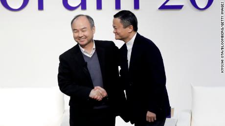 Masayoshi Son and Jack Ma shaking hands at a forum in Tokyo in 2019.