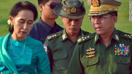 In this May 6, 2016, file photo, Aung San Suu Kyi, left, Myanmar&#39;s then foreign minister, walks with Senior Gen. Min Aung Hlaing, right, Myanmar military&#39;s commander in chief, in Naypyidaw.