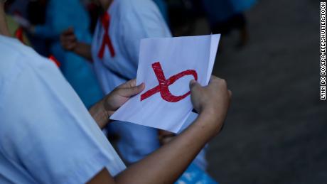 A medical staff holds a paper with the sign of red ribbon as a symbol of resistance against the military coup at Central Women&#39;s Hospital in Yangon, Myanmar, February 3, 2021. 
