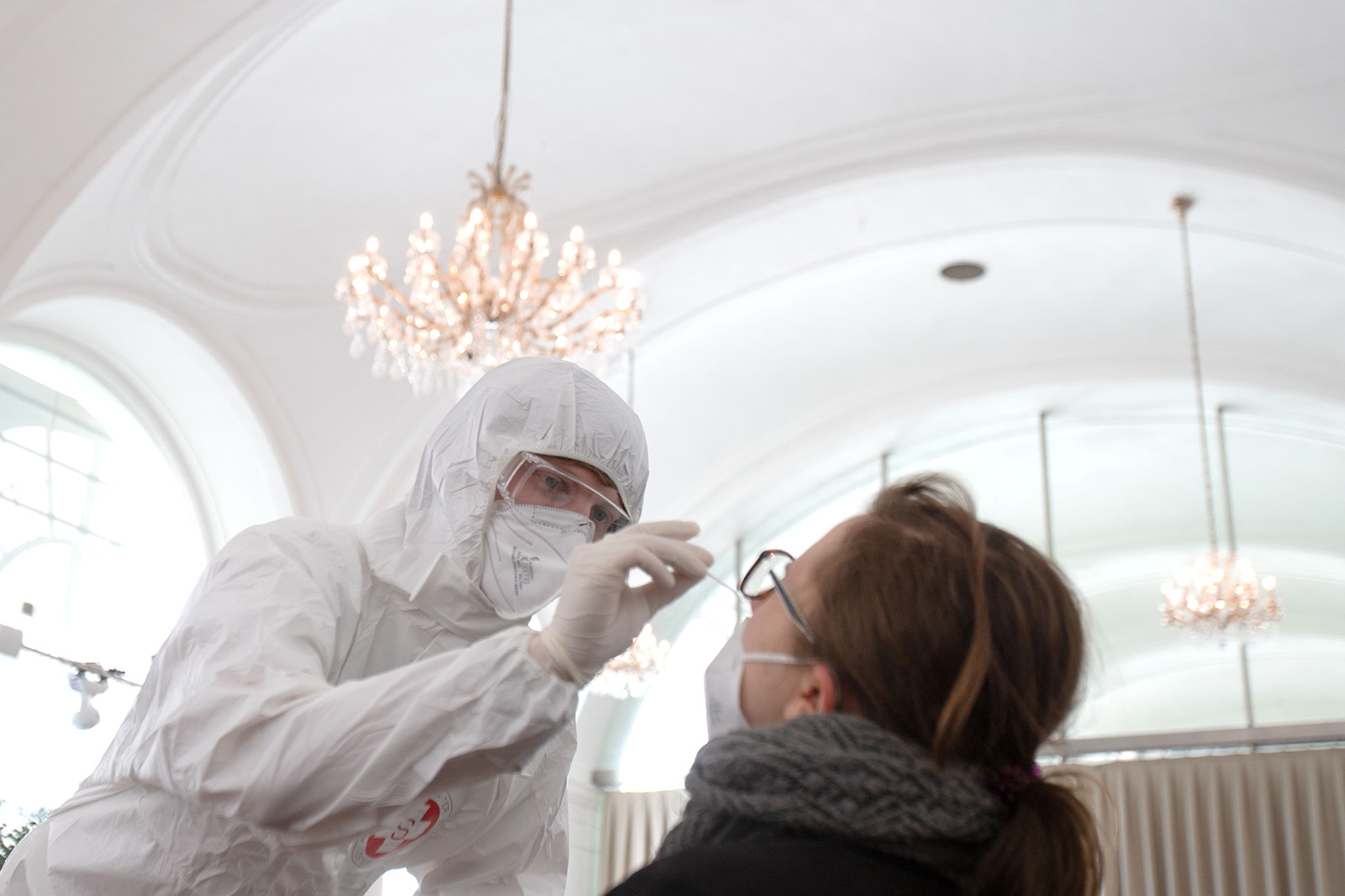 A health worker takes a coronavirus antigen rapid test swab at the new coronavirus test center in the Orangery of the Schoenbrunn Palace on February 4 in Vienna, Austria.