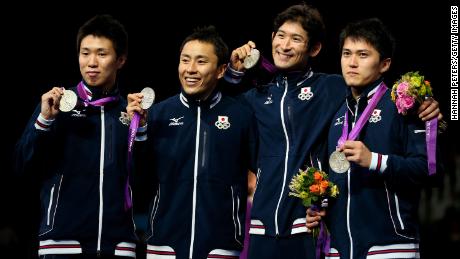 Miyake celebrates with his team after winning a silver medal at London 2012.
