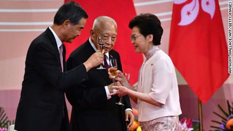 Hong Kong&#39;s Chief Executive Carrie Lam (right) makes a toast with former leaders Tung Chee-hwa (center) and Leung Chun-ying (left) following a ceremony to mark the 23rd anniversary of Hong Kong&#39;s handover on July 1, 2020.