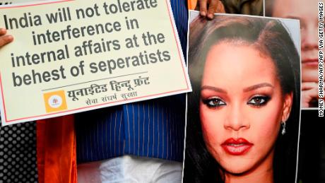 Members of the nationalist United Hindu Front hold an image of singer Rihanna during a demonstration in New Delhi on February 4.