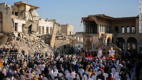 People attend a prayer led by Pope Francis for war victims at the Church Square in Mosul&#39;s Old City.