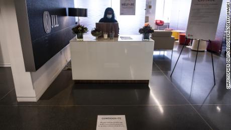 A social distancing marker is displayed in front of a reception desk at the JLL office in Chicago.