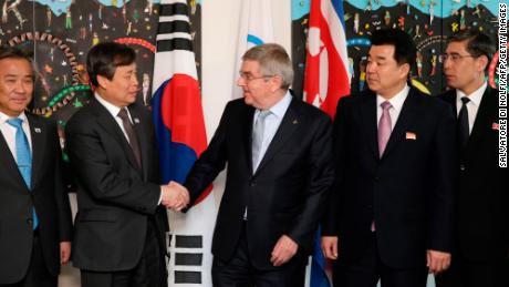 IOC president Thomas Bach (right)  shakes hands with South Korean Sports Minister Do Jong-hwan (second left) next to North Korea&#39;s Olympic Committee President and sports minister Kim Il Guk (second right).