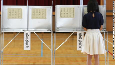 An 18-year-old woman casts her vote for parliament&#39;s upper house election at a polling station on July 10, 2016 in Himeji, Japan. 