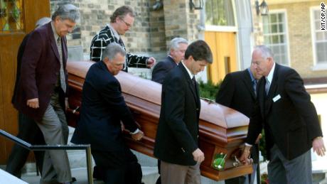 Pallbearers acccompany the coffin of Canadian golf legend Norman.