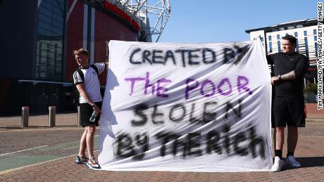 Football fans opposing the European Super League outside Old Trafford in Manchester. 
