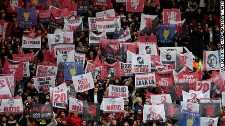 Manchester United fans hold up banners during their side&#39;s Champions League quarterfinal against Barcelona in 2019. 