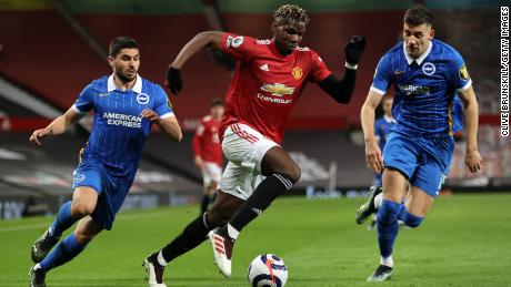 United midfielder Paul Pogba battles for possession with Jakub Moder (right) and Neal Maupay (left) of Brighton &amp; Hove Albion.