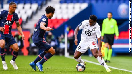 PSG&#39;s Marquinhos watches Jonathan David of Lille with the ball during the French Ligue 1 match between the two teams at the Parc des Princes on April 3.
