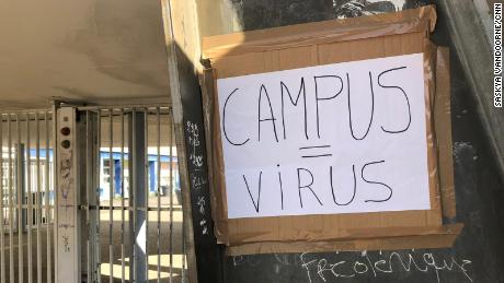 A handwritten placard reading &quot;Campus = Virus&quot; at Eugene Delacroix high school.