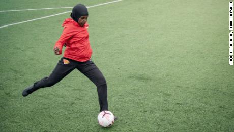 A player passes a ball while wearing a Nike Pro hijab.