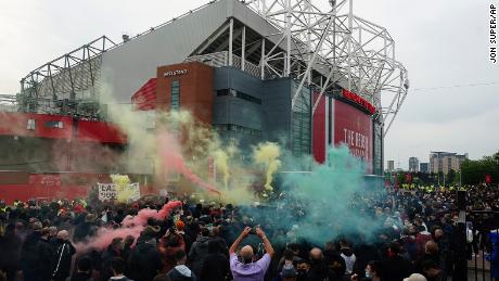 Manchester United fans let off flares as they protest against the Glazer family.