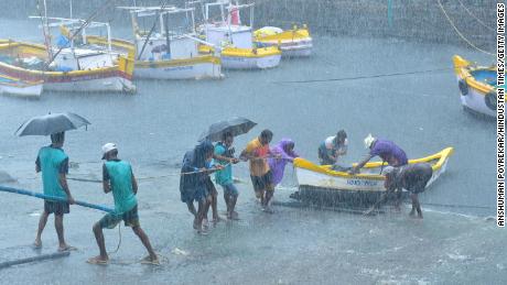 Fishermen pull their boats as Cyclone Tauktae approaches at Worli village, Mumbai, India, on May 17.