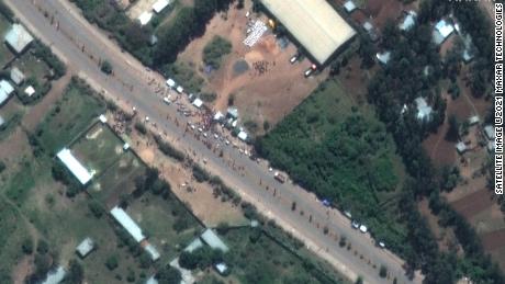 A crowd is seen outside the Guna distribution center on the outskirts of Shire, Ethiopia, in this satellite image captured on May 27. Detainees say they were beaten and tortured at the facility.