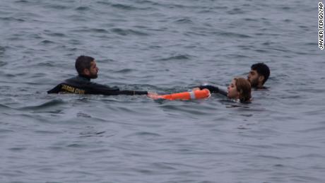 A Guardia Civil officer rescues people from the water.