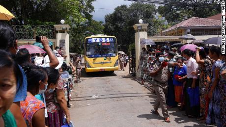 Relatives wait for a bus carrying prisoners to be released outside Insein Prison in Yangon on April 17.