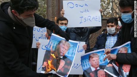 Students of Iran&#39;s Basij paramilitary force burn posters depicting Donald Trump and Joe Biden during at the foreign ministry in Tehran, on November 28, 2020, to protest the killing of prominent nuclear scientist Mohsen Fakhrizadeh a day earlier near the capital.