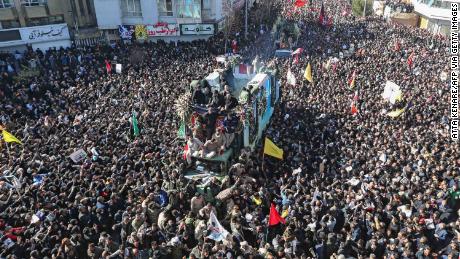 Iranian mourners gather around a vehicle carrying the coffin of slain top general Qasem Soleimani during the final stage of funeral processions, in his hometown Kerman on January 7, 2020.