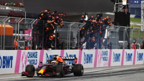 Verstappen takes the chequered flag as his team celebrate on the pitwall at the Styrian Grand Prix.