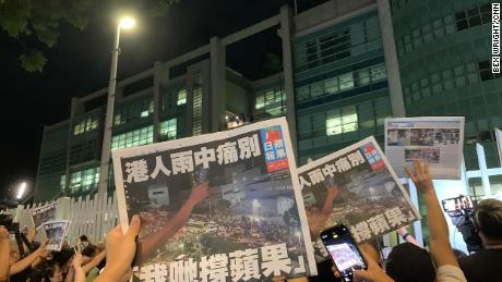 Free copies of the final Apple Daily issue being handed out to supporters through the gates in Hong Kong on July 23.