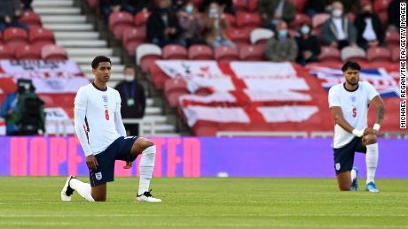 England players Jude Bellingham and Tyrone Mings of England take the knee ahead of the international friendly match against Austria at the Riverside Stadium on June 02, 2021 in Middlesbrough.
