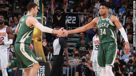 Brook Lopez high-fives Antetokounmpo during Game 3 of the NBA Finals.