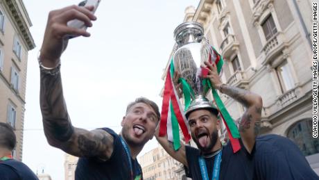 Ciro Immobile and Lorenzo Insigne celebrate with the Euro 2020 trophy.