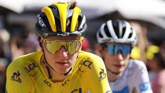 Tadej Pogacar of Slovenia wearing the overall leader's yellow jersey rides next to Team Jumbo Visma's Jonas Vingegaard of Denmark (R) wearing the best young's white jersey during the 21th and last stage of the 108th edition of the Tour de France cycling race.