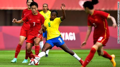 Shuang Wang and Formiga battle for possession.