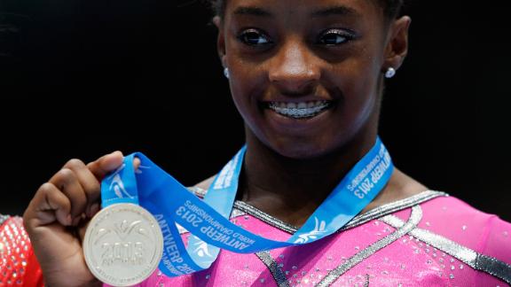 Biles poses after winning the gold medal in the floor exercise at the 2013 World Championships.
