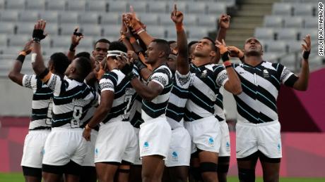 Fiji&#39;s players huddle together at the start of their gold medal match against New Zealand.