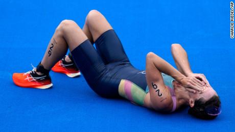 Flora Duffy of Bermuda celebrates after crossing the finish line to win the gold medal in the women&#39;s individual triathlon at 2020 Summer Olympics.