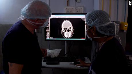 Surgeons examine an X-ray for signs of infection in Srinivas&#39; brain.