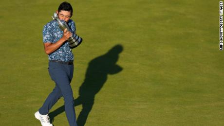 Morikawa celebrates with the Claret Jug on the 18th green after winning the Open.