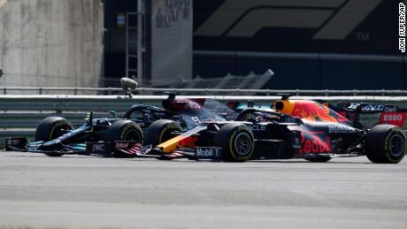 Hamilton and Max Verstappen take a curve side-by-side at the start of the British Grand Prix. 