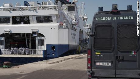 An Italian law enforcement vehicle parked next to the ship &quot;Geo Barents&quot; while migrants wait to disembark in Sicily on June 18.
