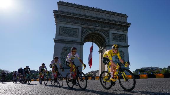 Slovenia's Tadej Pogacar, wearing the overall leader's yellow jersey, passes the Arc de Triomphe during the twenty-first and last stage of the Tour de France cycling race over 108.4 kilometers (67.4 miles) with start in Chatou and finish on the Champs Elysees in Paris, France,Sunday, July 18, 2021. (AP Photo/Daniel Cole)