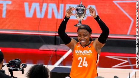 Arike Ogunbowale holds up the MVP trophy after dropping 26 points in the WNBA All-Star Game.