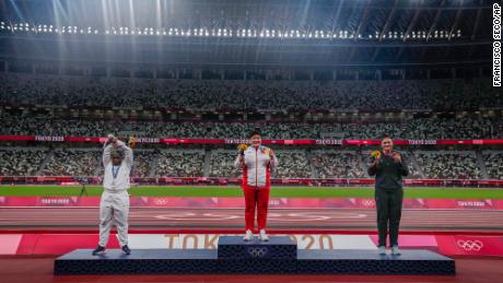 Saunders performing her X gesture on the shot put medal podium.