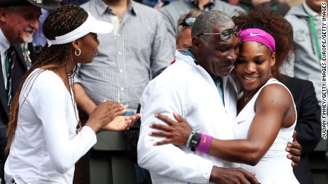 Serena Williams celebrates with her father, Richard Williams, and sister, Venus Williams, after the Wimbledon singles final match against Agnieszka Radwanska of Poland on July 7, 2012.