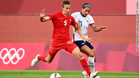 Canadian midfielder Quinn (in red) is the first trans and non-binary athlete to compete at the Olympics.