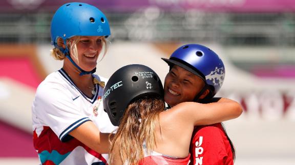 Sky Brown hugs Sakura Yosozumi during the women's skateboarding park finals at the Tokyo Olympics. 