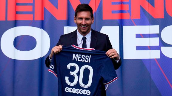 Messi holds his jersey after a press conference.