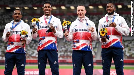Team GB 4x100m relay athletes pose with their silver medals at the Tokyo Olympics.