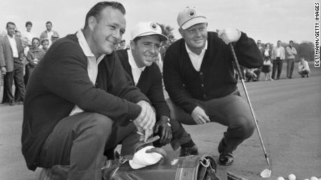 Palmer, Player and Nicklaus pose with their golf clubs before a practice round at the Firestone Country Club in Akron, Ohio.