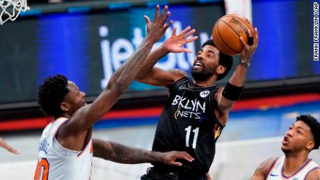 Brooklyn Nets&#39; Kyrie Irving (center) may be unable to play in front of NBA fans in New York City this season, following new vaccine mandates that could bar players from competing in home games if they are not vaccinated or exempted.